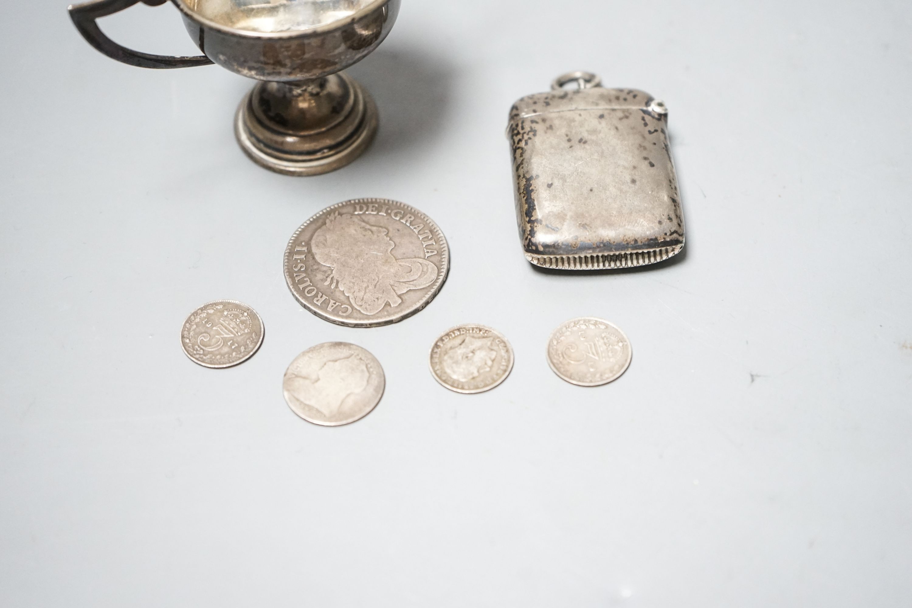 A silver vesta case, a small silver trophy cup and five assorted coins including a Charles II half crown, 1664.